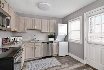 A kitchen with white appliances and wooden cabinets